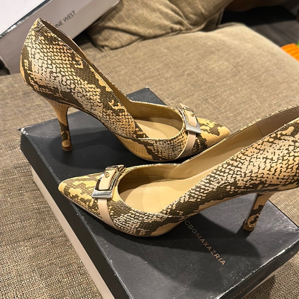 Snakeskin pointed toe heels with a buckle detail